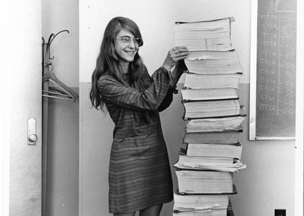 portrait of Margret Hamilton in from of the source code for the Apollo Guidance System